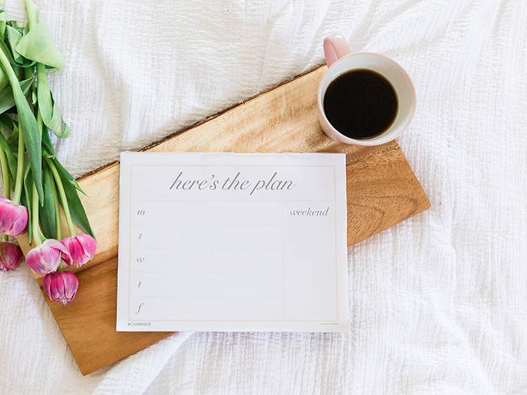 Planner with pink roses and coffee seated on a wooden tray